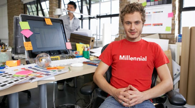 Image of young man millennial at work in front of a computer