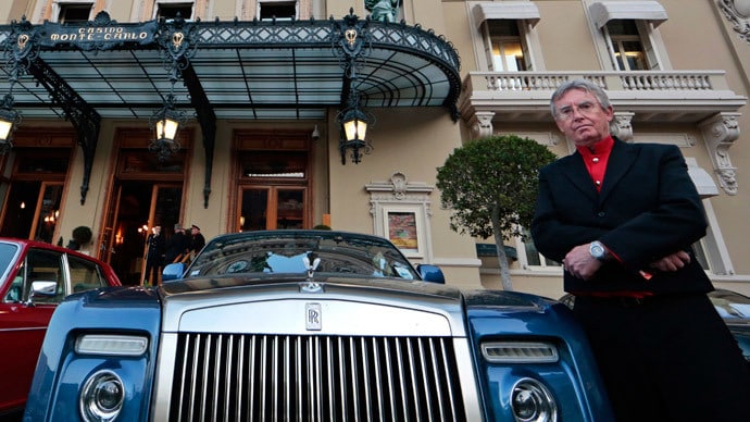 Picture of rich person in front of a fancy car wearing an expensive watch