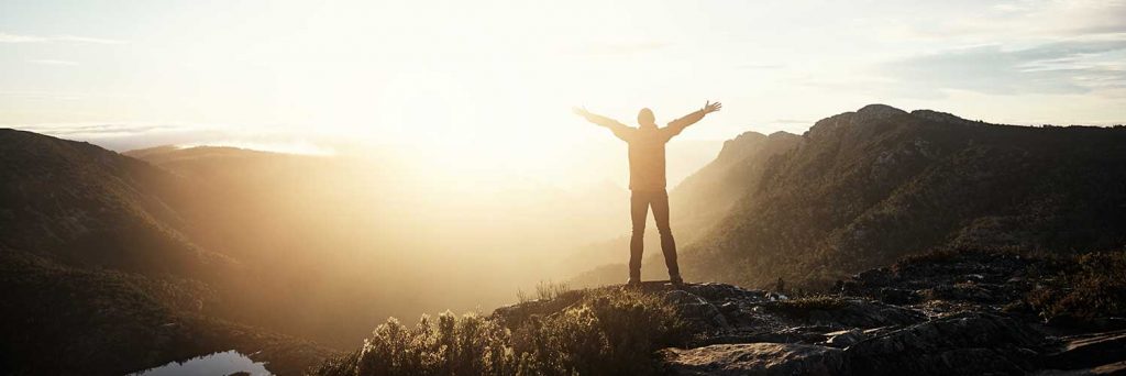 Nonprofit Jobs - image of person on a mountain ready to take on new challenges