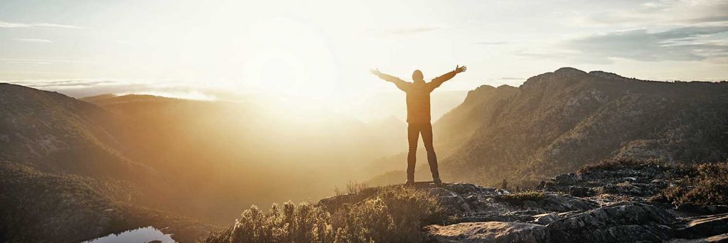 Nonprofit Jobs - image of person on a mountain ready to take on new challenges