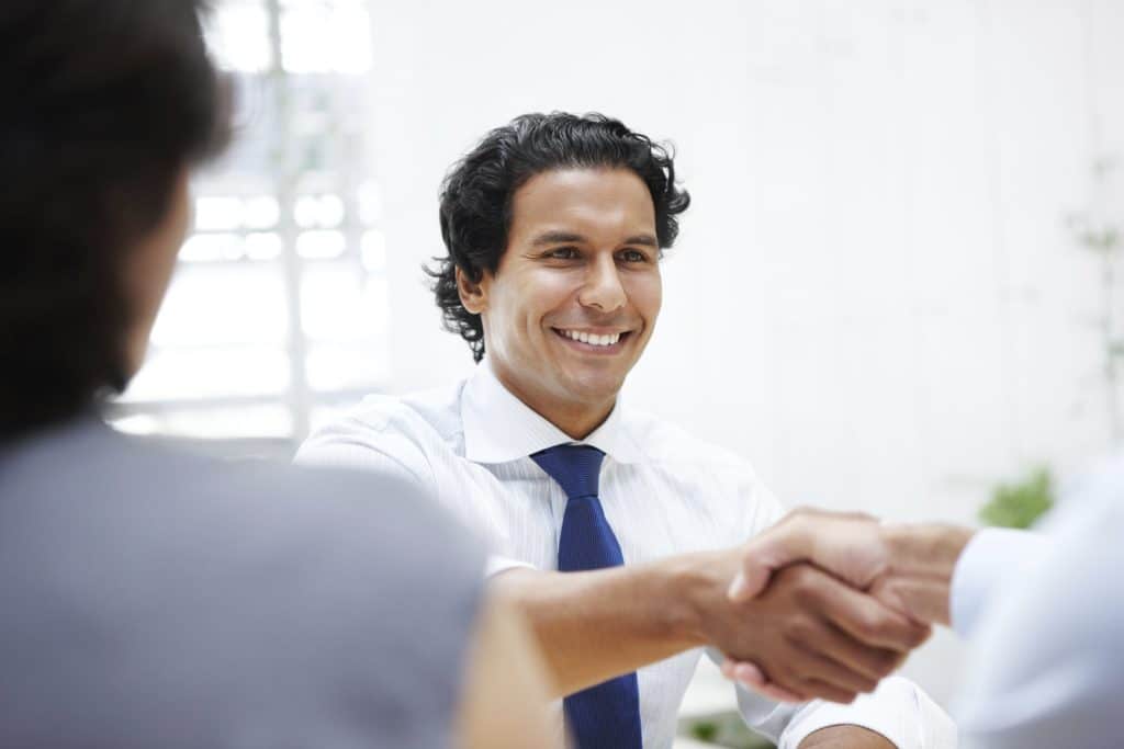 What is a nonprofit? Image of nonprofit worker shaking hands. 