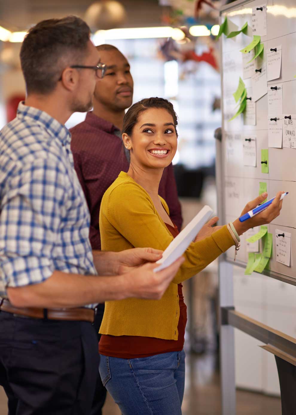 The team at a foundation at a whiteboard discussing who to hire for a new foundation job