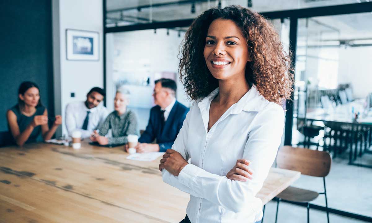 A woman smiles after giving a presentation to the board of her foundation