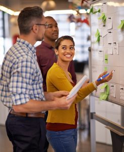 Education Job Postings - Education Staff Working at a cork board