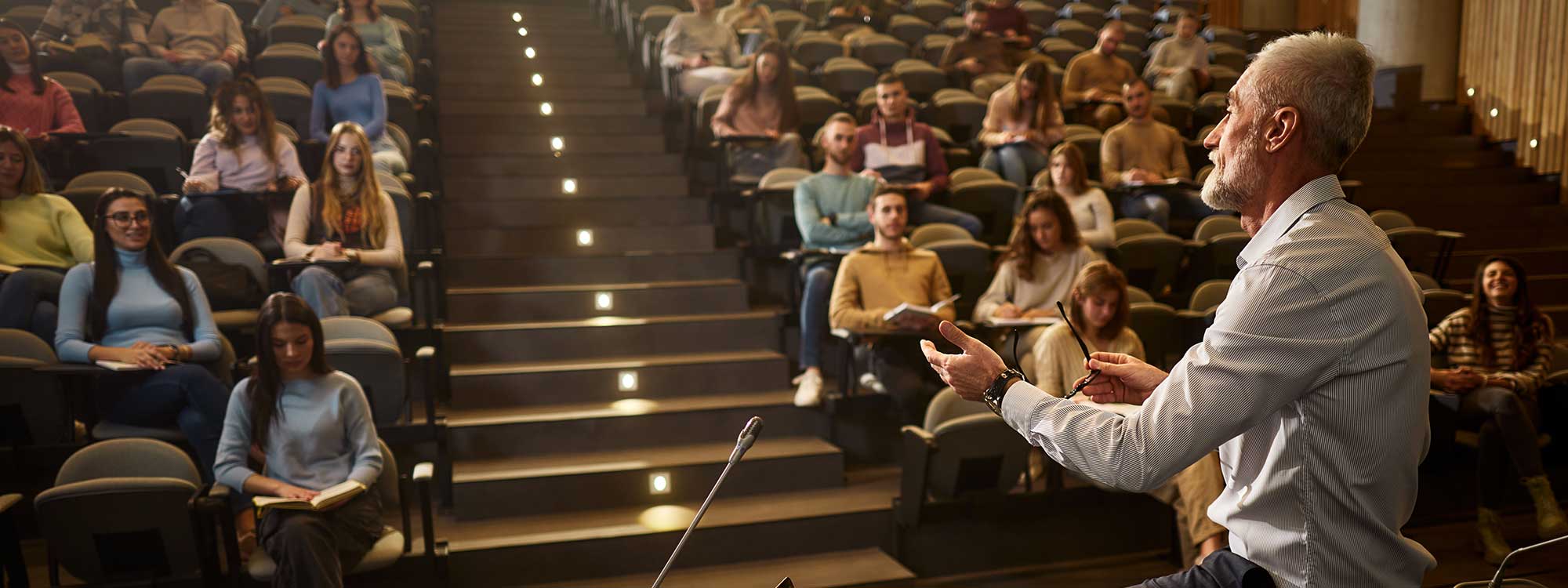 A college profession teachers a class in a lecture hall