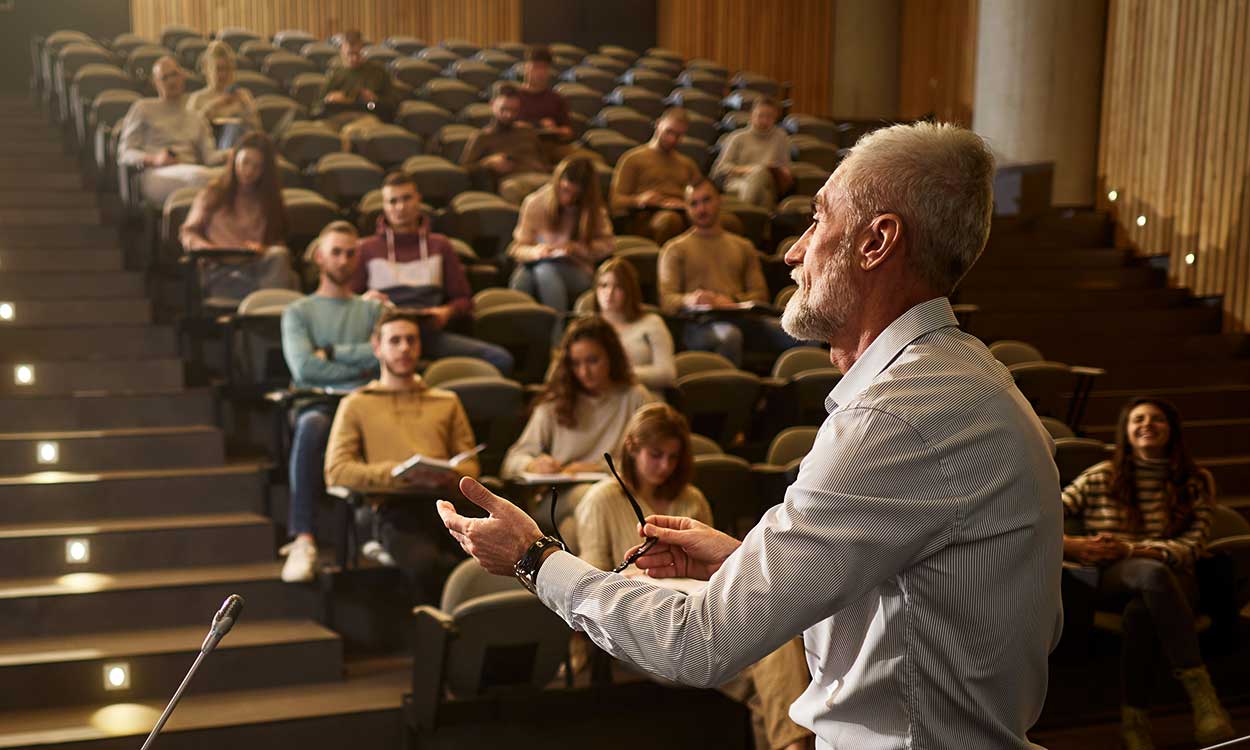 A college profession teachers a class in a lecture hall