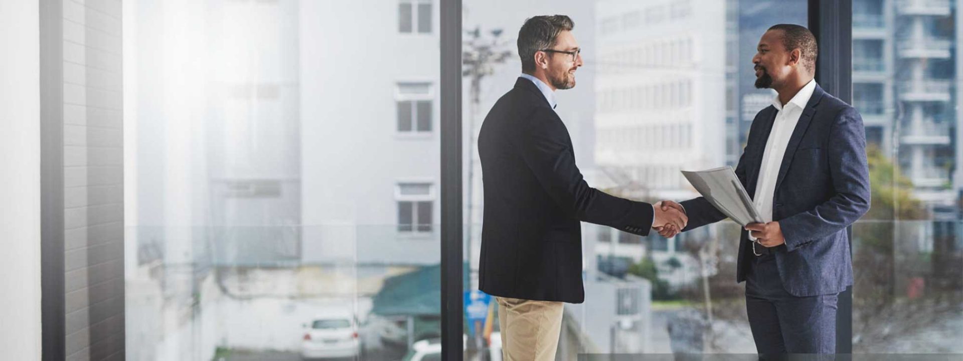 Image of two men shaking hands after meeting via a nonprofit job board