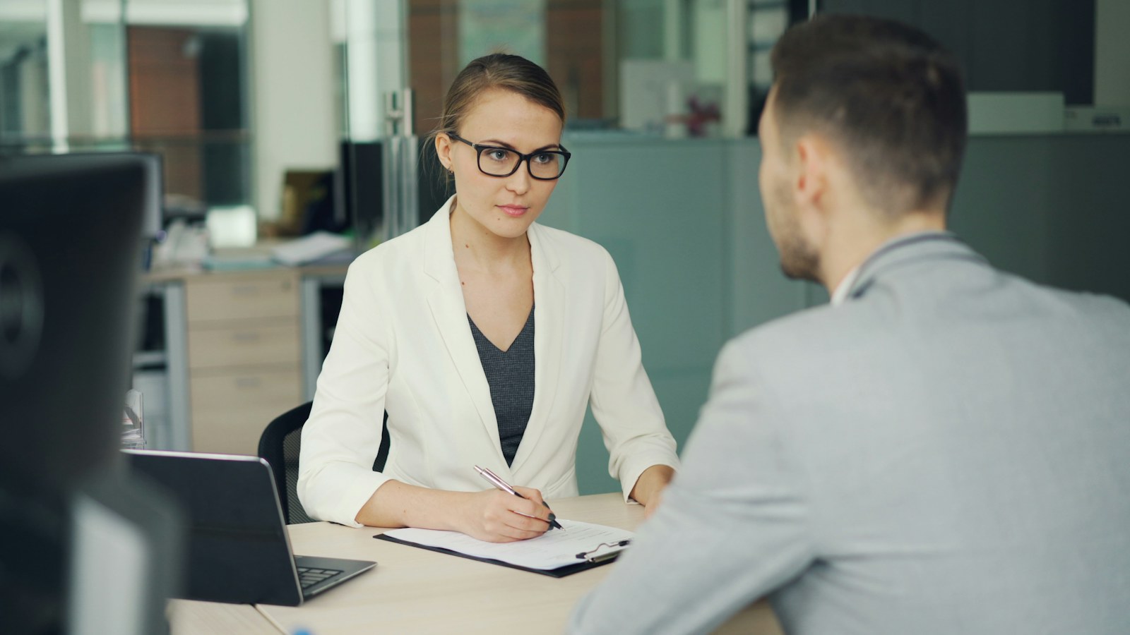 Employer interviewing a development director candidate in an office