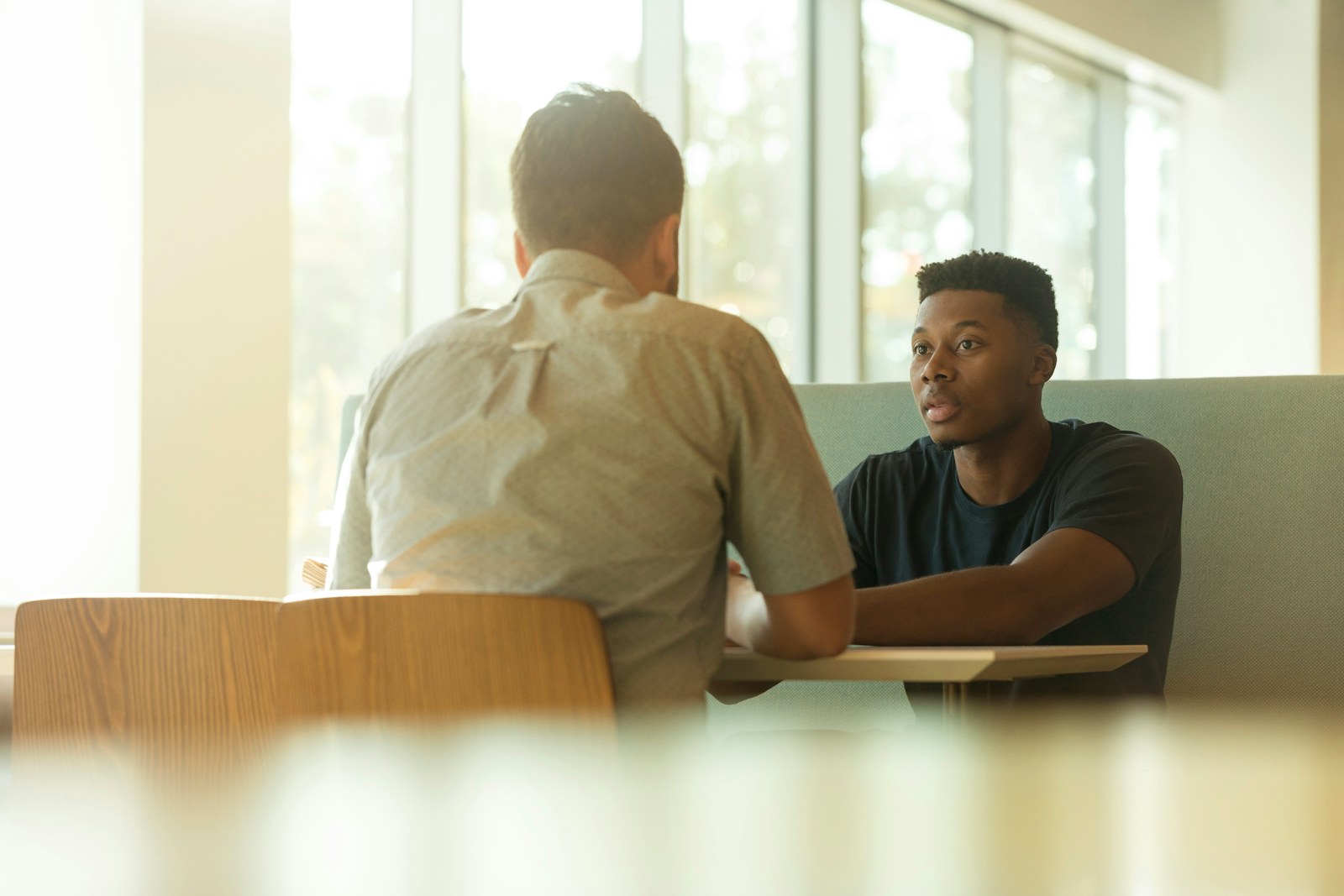 Two workplace leaders discussing compensation and role expectations