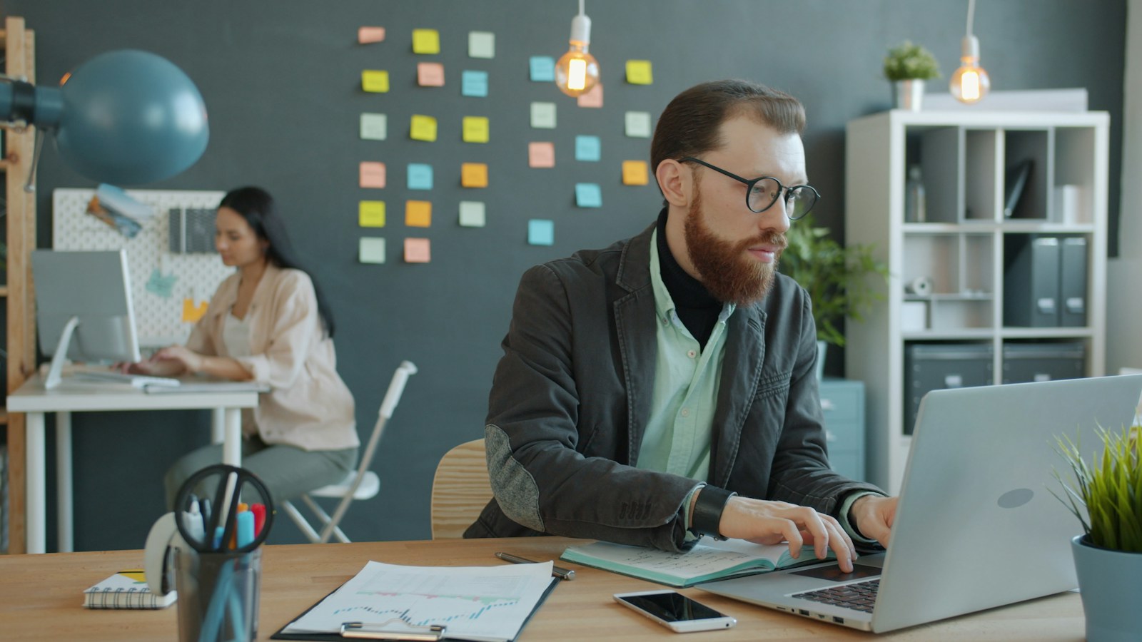 Manager guiding a new nonprofit employee through workplace documents