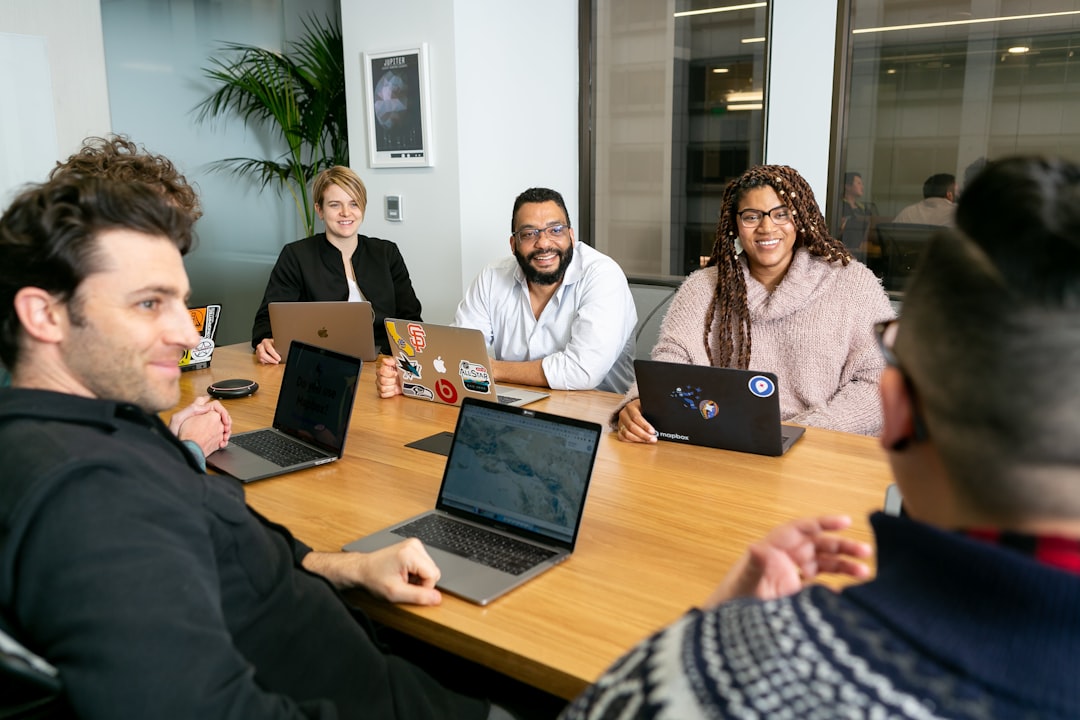 Executive support professionals coordinating priorities during an office meeting