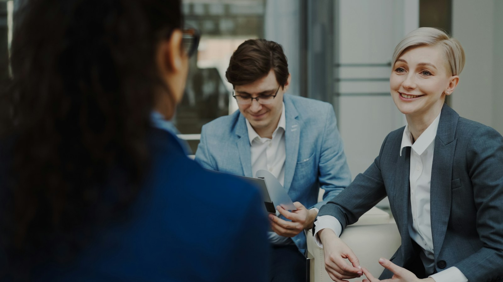 Hiring manager interviewing professionals in a modern office