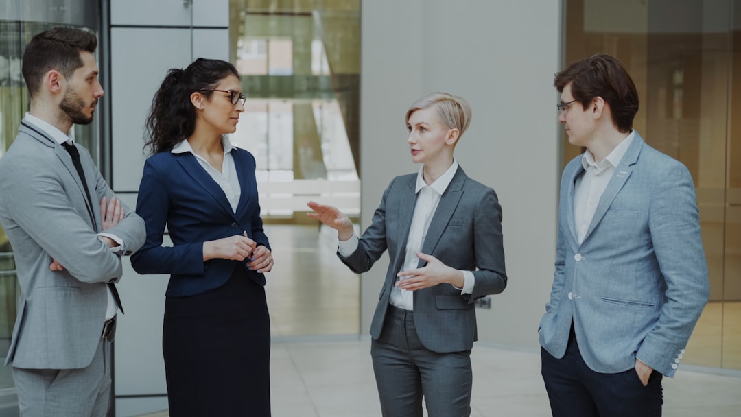 Professionals building relationships during a workplace networking conversation