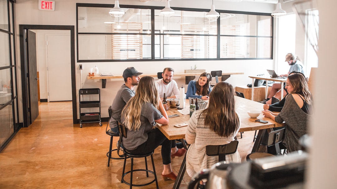Nonprofit program coordinators collaborating during a workplace meeting