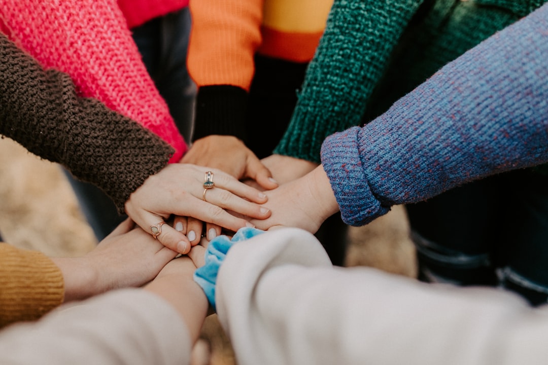 People and culture team joining hands during a nonprofit workplace workshop